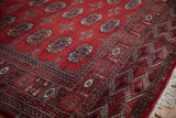 Lustrous wool pile and detailed geometric border on a vintage red Bokhara runner with ivory fringe.