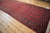 Repeating geometric gul medallions span the full length of this vintage Bokhara runner.