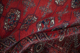 The lustrous pile and fine weave of a vintage Bokhara rug's gul medallions.