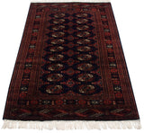 Angled perspective of a vintage Bokhara rug showing its lustrous pile and rows of geometric gul medallions.
