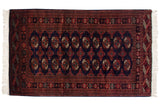Vintage fine Bokhara rug with repeating gul medallions in chestnut rust and ivory over a deep navy blue field.