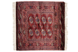 Plush vintage Bokhara pile with navy and ivory geometric gul medallions.