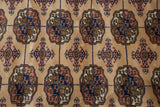 Fine weave of vintage Bokhara rug with camel, navy, and terracotta gul motifs.