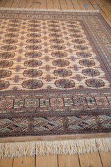 Creamy fringe and intricate navy, copper, ivory geometric border patterns.