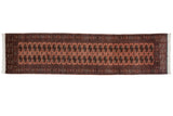 Vintage Bokhara rug runner with navy and ivory gul medallions on a dusty rose copper field.