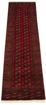 Cherry red Bokhara runner corner with gul medallions, ornate border, intact selvage, white fringe.