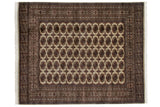 Vintage Fine Bokhara carpet with repeating brown and blue gul medallions on a lustrous ivory field.