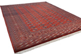 Angled perspective of a vintage Bokhara carpet, showing the plush wool pile and repeating gul motifs.