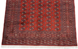 The intricate end border and clean ivory fringe on a hand-knotted vintage Bokhara carpet.