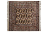 Extremely detailed gul medallions in a repeating geometric pattern on a vintage Bokhara rug.