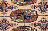 Finely knotted gul medallion on a vintage Bokhara rug with a plush, silk-like wool pile.