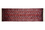 A fine vintage Bokhara rug runner with repeating gul medallions in wine red, navy blue, and ivory.