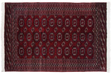 A finely woven vintage Bokhara carpet with repeating gul medallions in rich wine red, navy, and silver.