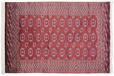 The fine weave and lustrous red pile showing detailed navy and ivory gul medallions.