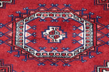 A tight, fine weave highlights the detail of a traditional Bokhara gul medallion in red and navy.
