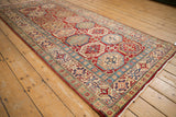 New Pakistani Kazak rug corner showcasing ivory fringe, red selvage, and jade green border.
