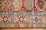 Moghan style Kazak rug border, sapphire blue with cherry red geometric star motifs.