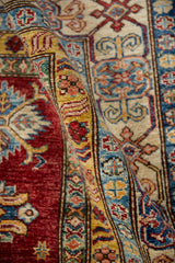 Textured cherry red field and saffron yellow meandering vine border detail.