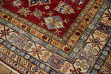 Cherry red field with geometric floral pinwheel motifs and ivory crab vine border.