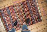Hand knotted Pakistani Khorjin design rug with vibrant striped geometric patterns and gem-tone colors, 2'6