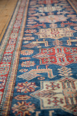 Close-up of sapphire blue field with cherry red quatrefoil florals and finned birds.