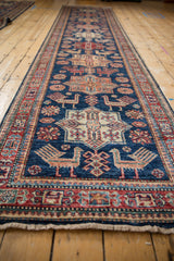 Finned birds and quatrefoil floral motifs on a sapphire blue Pakistani Caucasian design runner.