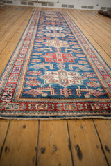 Sapphire blue field with cherry red geometric medallions and finned bird motifs.