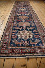 Pakistani Caucasian design rug border with geometric motifs and finned birds on a sapphire blue field.