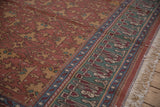 Indian Lotto Soumac rug border in pistachio green, faded red, with ivory fringe.