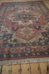 Vintage Indian Soumac rug showing madder red field patterns, dusty teal border, and fringe.