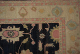 Corner detail of Sultanabad Soumac carpet with antique ivory borders and dark floral field.