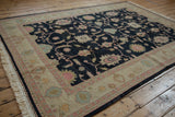 Vintage Indian Sultanabad Soumac carpet corner with charcoal field, antique ivory border, dusty rose florals.