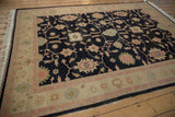 Indian Sultanabad rug detail: charcoal field, dusty rose serrated florals, beige border.