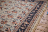 Traditional Serapi Soumac rug: dusty navy border, antique ivory field with terracotta floral vinery.