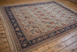 Fringe and intact selvage of a vintage Serapi rug with dusty navy floral border.