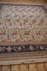 Repeating Serapi floral vines and petals in antique ivory, dusty navy, and terracotta.