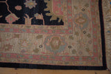 Vintage Indian Soumac rug with prominent beige and faded raspberry borders, charcoal navy field detail, and natural fringe.