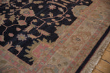 Delicate vinery on charcoal field meets patterned sand border of a vintage Indian Soumac rug.