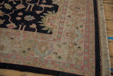 Vintage Indian Sultanabad Soumac border corner with serrated florals, dark field, and beige fringe.