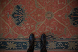 Close view of the Arts and Crafts floral palmettes and trellis design in terracotta and navy.
