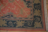 Corner of a vintage Indian rug with a navy Arts and Crafts border and original fringe.