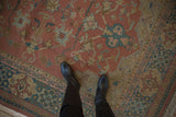 Madder root rust Indian Serapi Soumac carpet featuring dusty teal arabesque patterns under boots.