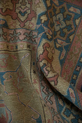 Folded detail of Soumac carpet showing dusty teal, madder rust, and pawn motifs.