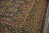 Soumac carpet's dark olive reciprocating wave border, dusty teal field, and fringe.