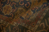 Textured fold of vintage Soumac carpet with dusty teal cartouches and madder root wave border.