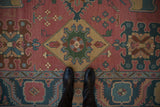 Northwest Persian Soumac rug detail: interlocking medallions and finials in rose, dusty teal, saffron.