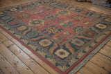 Vintage Indian Soumac carpet border and field with raspberry rose, teal, and beige patterns.