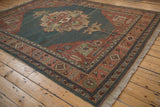 Vintage Serapi rug with abrashed dusty teal field and madder red floral medallion.