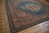 Hand-knotted beige fringe and terracotta border with geometric floral motifs.