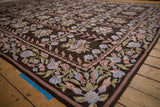 Corner of vintage Chainstitch carpet showing flowering vines, dusty blue, mauve, olive green.